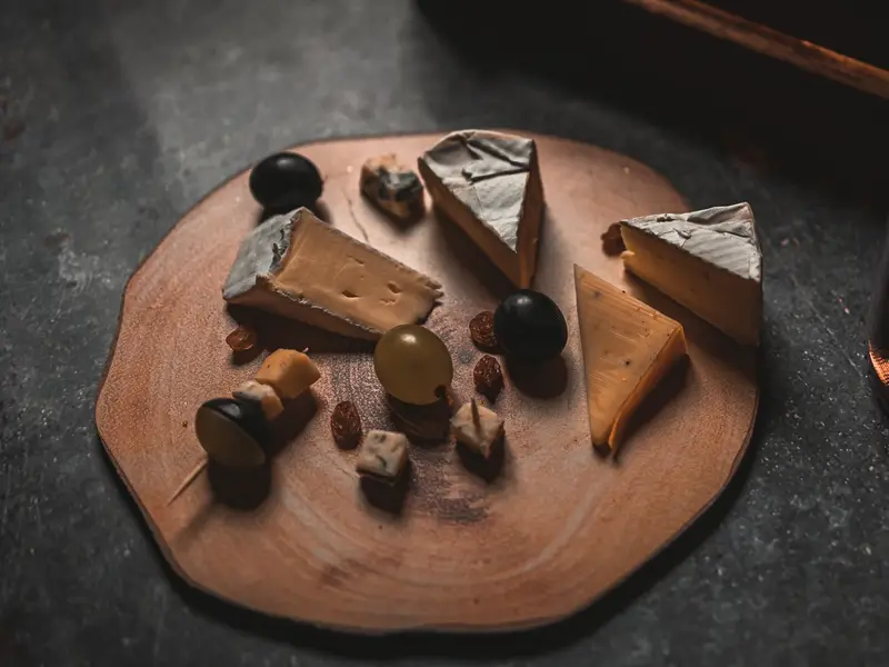 A cheese board with grapes